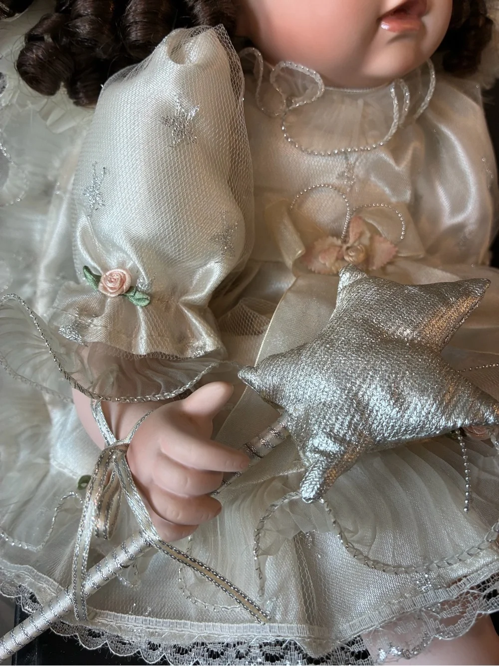 Vintage porcelain doll holding wand and wearing halo